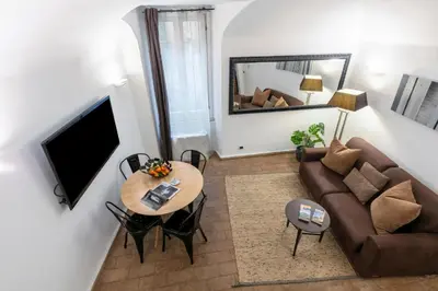 a living room with a couch and a table at Velantia Fori Apartment in Rome