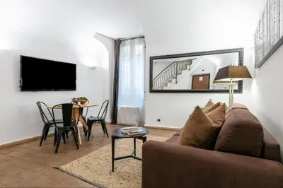 a living room with a couch and a table at Velantia Fori Apartment in Rome
