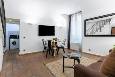 a living room with a couch and a table at Velantia Fori Apartment in Rome
