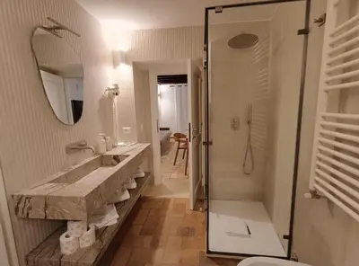 a bathroom with a green sink and a toilet at Velantia Fori Apartment in Rome
