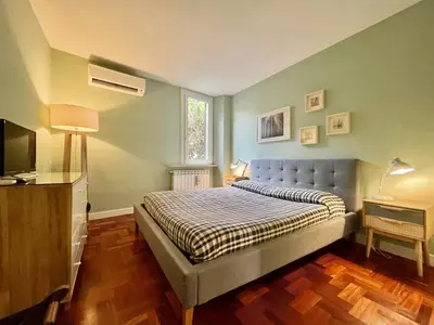 a bedroom with a bed and a television in it at Calisto 6 in Rome