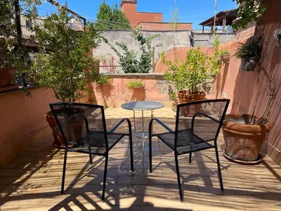 two chairs and a table on a patio at Calisto 6 in Rome
