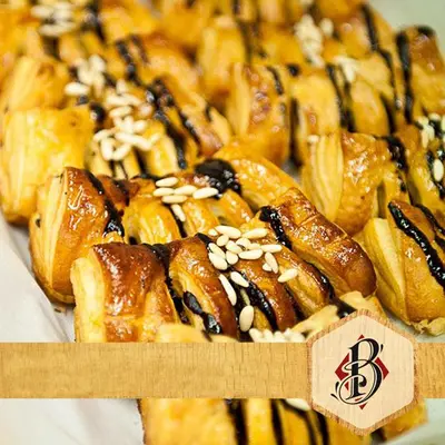 a bunch of pastries in a box with sesame at Calisto 6 in Rome