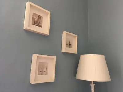 a wall with framed pictures on a wall with a lamp at Calisto 6 in Rome