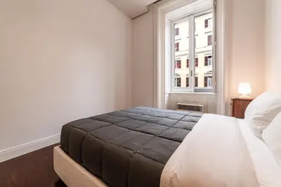 a bedroom with a large bed and a window at Casa Lavinia - Basilica Santa Maria Maggiore in Rome
