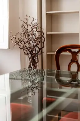 a glass table with a chair and a vase of flowers at Casa Lavinia - Basilica Santa Maria Maggiore in Rome