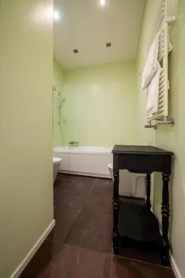 a bathroom with a table and a bath tub at Casa Lavinia - Basilica Santa Maria Maggiore in Rome
