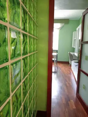 a room with a wall filled with green plants at Rome full apt 4 people close to Colosseum Mao house in Rome