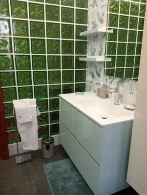 a bathroom with a sink and a green tiled wall at Rome full apt 4 people close to Colosseum Mao house in Rome