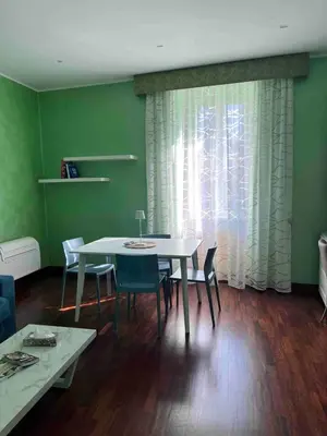 a dining room with a white table and chairs at Rome full apt 4 people close to Colosseum Mao house in Rome