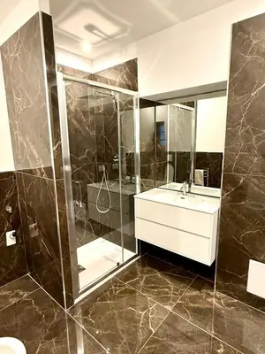 a bathroom with a shower and a sink and a mirror at Domus Mantellate, Trastevere in Rome