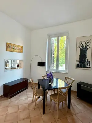 a dining room with a black table and chairs at Domus Mantellate, Trastevere in Rome