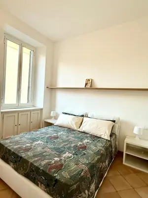 a bedroom with a bed and a window at Domus Mantellate, Trastevere in Rome