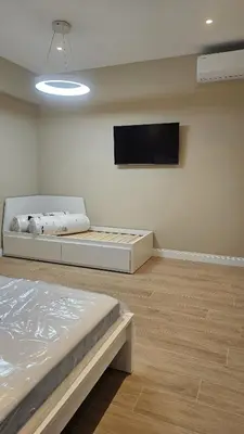 a room with a bed and a flat screen tv at La Belle Étoile in Rome