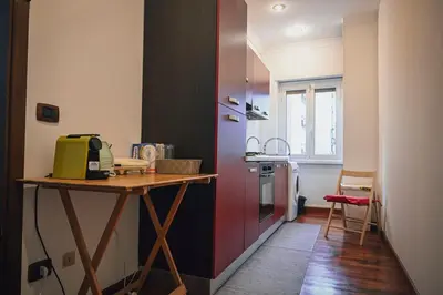 a kitchen with a table and a counter with a stove at Room in Rome in Rome