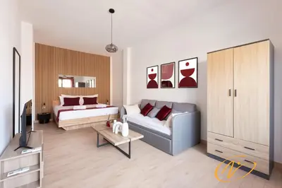 a living room with a couch and a bed at Nuccia Luxury Apartment and Suites - Terrace, bright glass lounge, 200mt to Metro-5min to Vatican, A-C in Rome