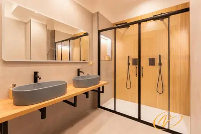 a bathroom with two sinks and a shower at Nuccia Luxury Apartment and Suites - Terrace, bright glass lounge, 200mt to Metro-5min to Vatican, A-C in Rome