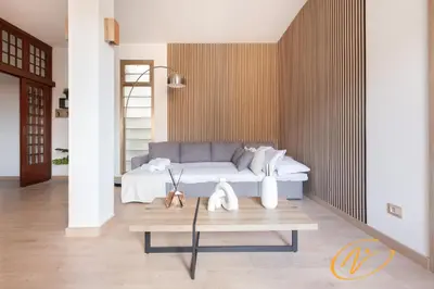 a living room with a bed and a coffee table at Nuccia Luxury Apartment and Suites - Terrace, bright glass lounge, 200mt to Metro-5min to Vatican, A-C in Rome
