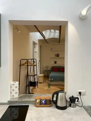 a kitchen with a counter top and a room with a bed at Navona Sweet Home in Rome