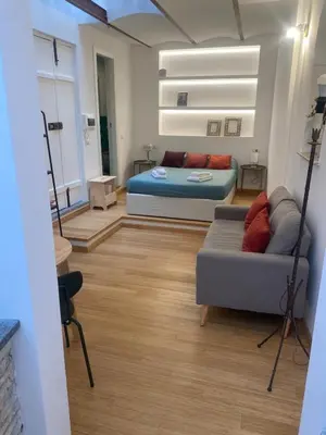 a living room with a bed and a couch at Navona Sweet Home in Rome