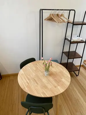 a wooden table with two chairs and a vase with flowers at Navona Sweet Home in Rome