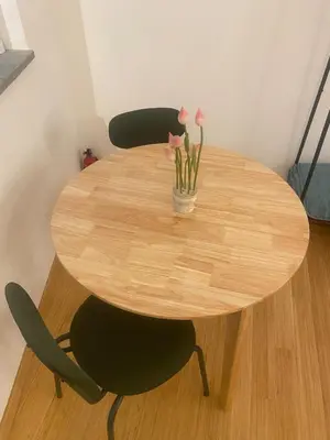 a wooden table with two chairs and a vase of flowers at Navona Sweet Home in Rome