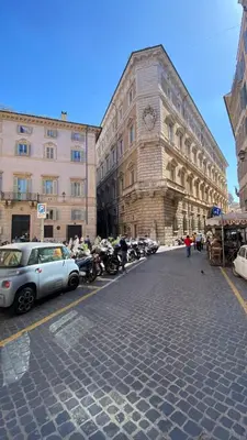 a building with a clock on the side of a street at Navona Sweet Home in Rome
