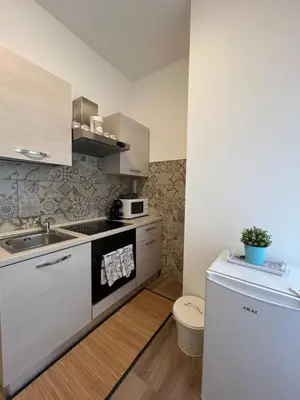 a small kitchen with a sink and a toilet at Interno 2 alle Mura in Rome