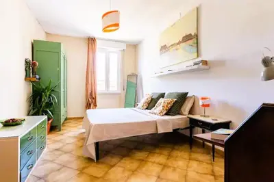 a room with a bed and a couch in it at Ampia stanza luminosa a San Giovanni, piano alto con finestra o balcone in Rome