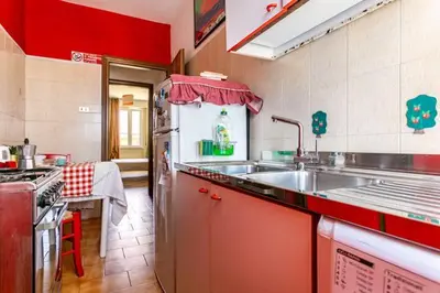 a kitchen with a sink and a stove at Ampia stanza luminosa a San Giovanni, piano alto con finestra o balcone in Rome