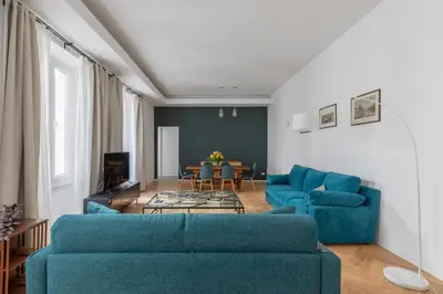 a living room with two blue couches and a table at iFlat The Sweet Life in Rome in Rome
