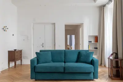 a blue couch sitting in a living room at iFlat The Sweet Life in Rome in Rome