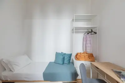 a small bedroom with a bed and a desk and a chair at iFlat The Sweet Life in Rome in Rome