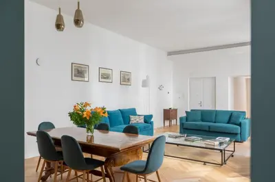 a living room with blue couches and a table at iFlat The Sweet Life in Rome in Rome