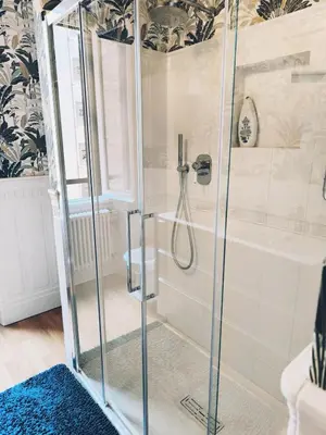 a shower with a glass enclosure in a bathroom at Elegant apartment 5 minutes from the subway in Rome