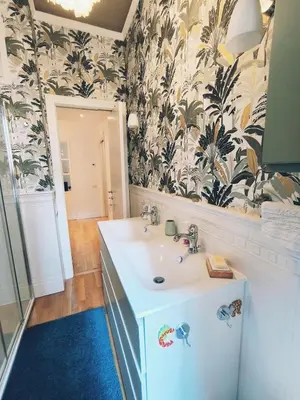 a bathroom with a sink and a mirror at Elegant apartment 5 minutes from the subway in Rome