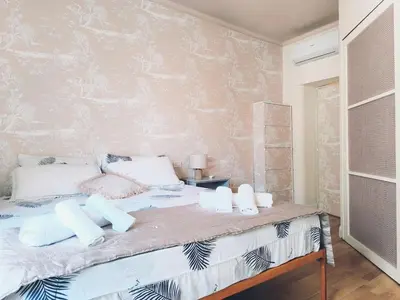 a bedroom with a large bed with white pillows at Elegant apartment 5 minutes from the subway in Rome