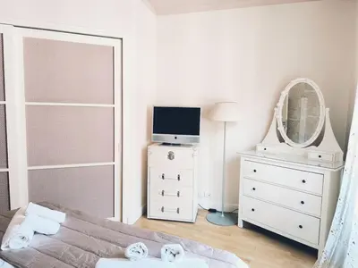 a bedroom with a bed and a mirror and a dresser at Elegant apartment 5 minutes from the subway in Rome