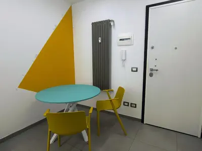 a room with a table and two chairs and a door at Casa di Eu - WelcomeToRhome in Rome