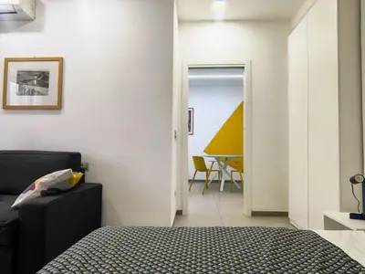 a bedroom with a bed and a dining room at Casa di Eu - WelcomeToRhome in Rome