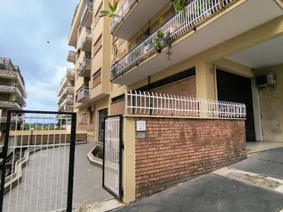 an apartment building with a gate and a brick wall at Casa di Eu - WelcomeToRhome in Rome