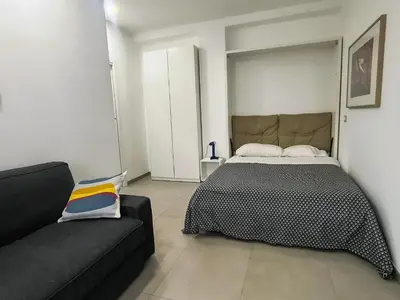 a bedroom with a bed and a couch at Casa di Eu - WelcomeToRhome in Rome