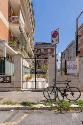 a bike parked next to a gate in front of a building at NOSTROMONDO-Playful & Modern Apartment in the heart of Pigneto in Rome