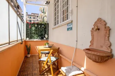 a balcony with a wooden table and a sink at NOSTROMONDO-Playful & Modern Apartment in the heart of Pigneto in Rome