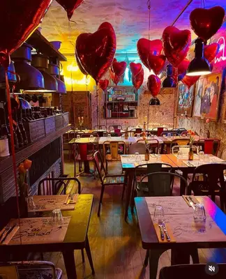 a restaurant with heart balloons hanging from the ceiling at Da Brando Loft PONTE MILVIO in Rome