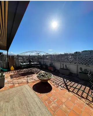 a patio with a table and a bowl on a roof at Da Brando Loft PONTE MILVIO in Rome