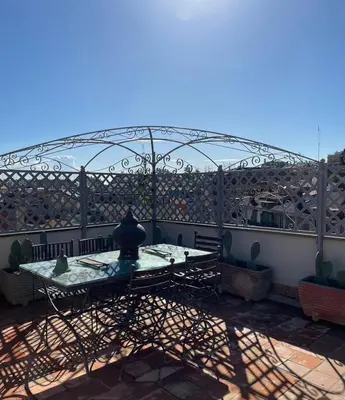 a patio with a table and a glass dome at Da Brando Loft PONTE MILVIO in Rome