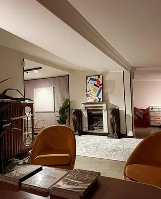 a living room with two chairs and a fireplace at Da Brando Loft PONTE MILVIO in Rome