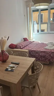 a dining room with a table and a bed at Imera House City Retreat in Rome