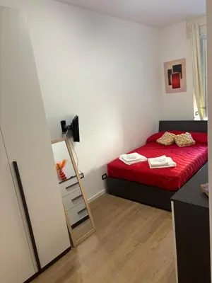 a small bedroom with a red bed and a mirror at Imera House City Retreat in Rome